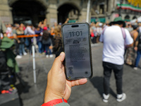 A person shows the cell phone earthquake alert during the national earthquake drill with a magnitude of 7.5 on the Richter scale with an epi...