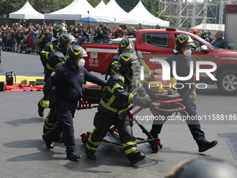 Rescuers and firefighters simulate an accident caused by the collapse of a building during the national earthquake drill with a magnitude of...