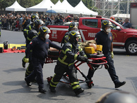 Rescuers and firefighters simulate an accident caused by the collapse of a building during the national earthquake drill with a magnitude of...