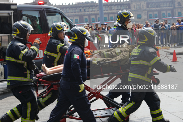 Rescuers and firefighters simulate an accident caused by the collapse of a building during the national earthquake drill with a magnitude of...