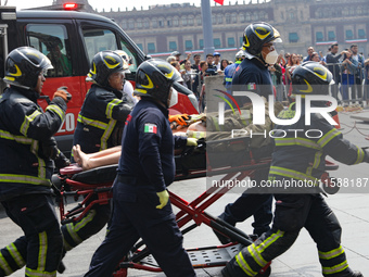 Rescuers and firefighters simulate an accident caused by the collapse of a building during the national earthquake drill with a magnitude of...