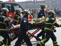 Rescuers and firefighters simulate an accident caused by the collapse of a building during the national earthquake drill with a magnitude of...