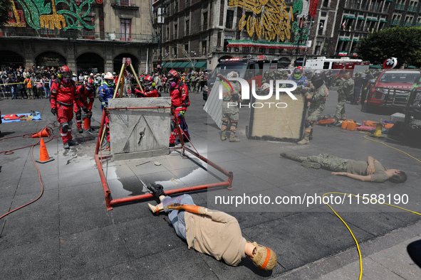 Rescuers and firefighters simulate an accident caused by the collapse of a building during the national earthquake drill with a magnitude of...