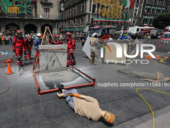 Rescuers and firefighters simulate an accident caused by the collapse of a building during the national earthquake drill with a magnitude of...