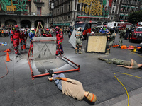 Rescuers and firefighters simulate an accident caused by the collapse of a building during the national earthquake drill with a magnitude of...