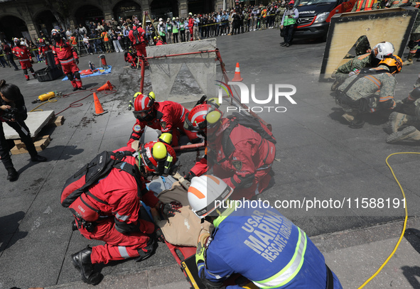 Rescuers and firefighters simulate an accident caused by the collapse of a building during the national earthquake drill with a magnitude of...