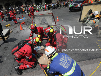 Rescuers and firefighters simulate an accident caused by the collapse of a building during the national earthquake drill with a magnitude of...