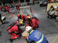 Rescuers and firefighters simulate an accident caused by the collapse of a building during the national earthquake drill with a magnitude of...