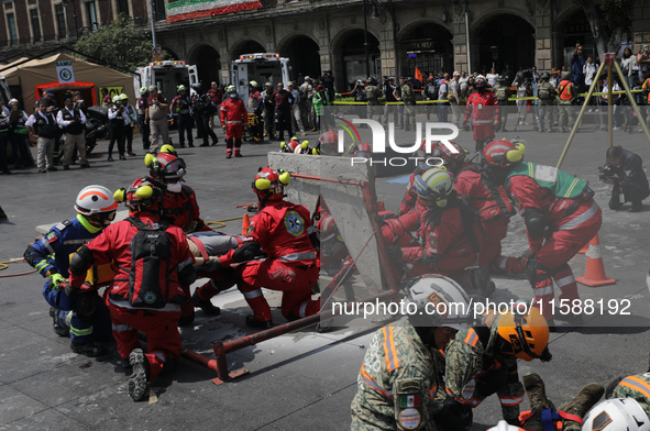 Rescuers and firefighters simulate an accident caused by the collapse of a building during the national earthquake drill with a magnitude of...