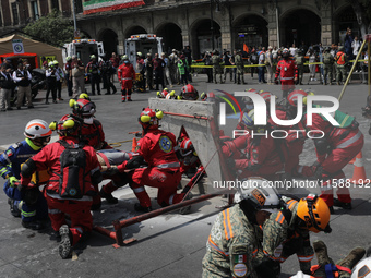 Rescuers and firefighters simulate an accident caused by the collapse of a building during the national earthquake drill with a magnitude of...