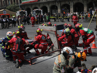 Rescuers and firefighters simulate an accident caused by the collapse of a building during the national earthquake drill with a magnitude of...