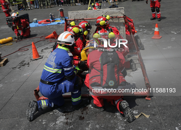 Rescuers and firefighters simulate an accident caused by the collapse of a building during the national earthquake drill with a magnitude of...