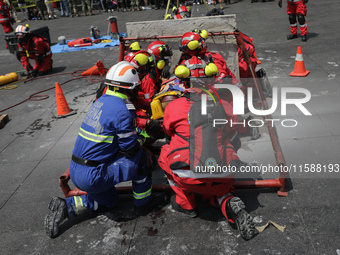 Rescuers and firefighters simulate an accident caused by the collapse of a building during the national earthquake drill with a magnitude of...