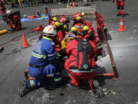 Rescuers and firefighters simulate an accident caused by the collapse of a building during the national earthquake drill with a magnitude of...