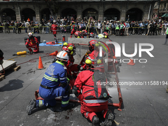 Rescuers and firefighters simulate an accident caused by the collapse of a building during the national earthquake drill with a magnitude of...