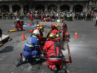 Rescuers and firefighters simulate an accident caused by the collapse of a building during the national earthquake drill with a magnitude of...