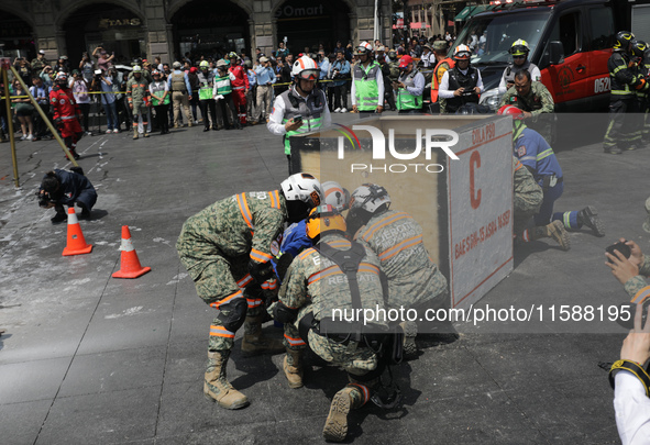 Rescuers and firefighters simulate an accident caused by the collapse of a building during the national earthquake drill with a magnitude of...