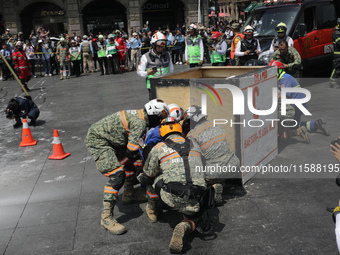 Rescuers and firefighters simulate an accident caused by the collapse of a building during the national earthquake drill with a magnitude of...