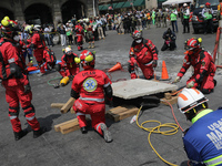 Rescuers and firefighters simulate an accident caused by the collapse of a building during the national earthquake drill with a magnitude of...