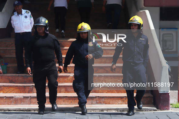 Members of the Fire Department take part in the 2024 national drill of a hypothetical earthquake of magnitude 7.5 on the Richter scale with...