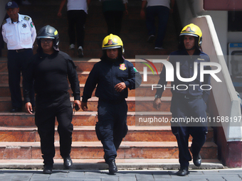 Members of the Fire Department take part in the 2024 national drill of a hypothetical earthquake of magnitude 7.5 on the Richter scale with...