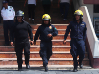 Members of the Fire Department take part in the 2024 national drill of a hypothetical earthquake of magnitude 7.5 on the Richter scale with...