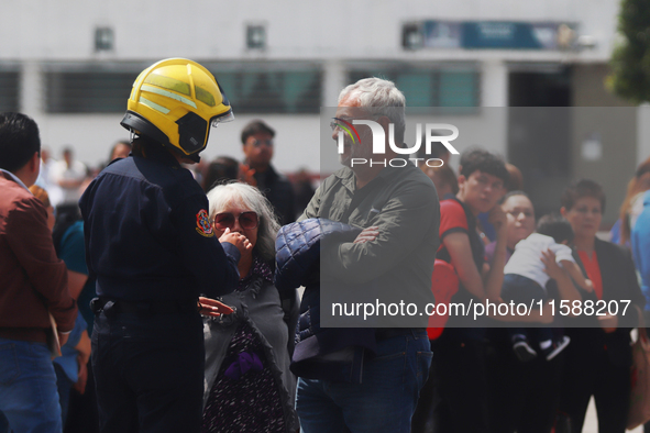 Members of the Fire Department take part in the 2024 national drill of a hypothetical earthquake of magnitude 7.5 on the Richter scale with...