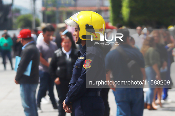 Members of the Fire Department take part in the 2024 national drill of a hypothetical earthquake of magnitude 7.5 on the Richter scale with...