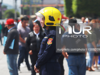 Members of the Fire Department take part in the 2024 national drill of a hypothetical earthquake of magnitude 7.5 on the Richter scale with...