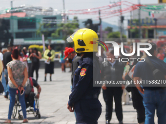 Members of the Fire Department take part in the 2024 national drill of a hypothetical earthquake of magnitude 7.5 on the Richter scale with...