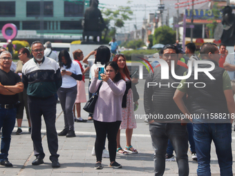 Mexican citizens take part in the 2024 National drill for a hypothetical earthquake of magnitude 7.5 on the Richter scale with an epicenter...