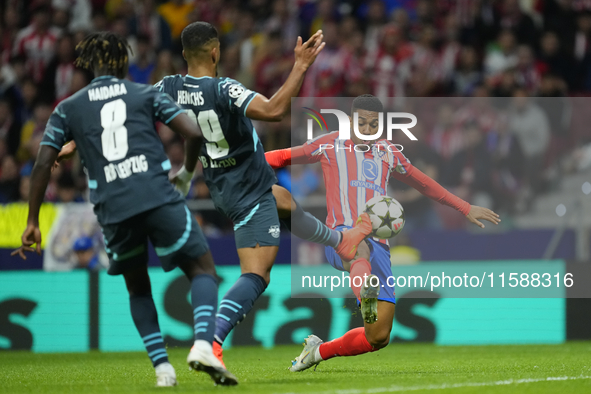 Samuel Lino left winger of Atletico de Madrid and Brazil and Benjamin Henrichs right-back of RB Leipzig and Germany compete for the ball dur...