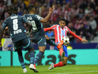 Samuel Lino left winger of Atletico de Madrid and Brazil and Benjamin Henrichs right-back of RB Leipzig and Germany compete for the ball dur...