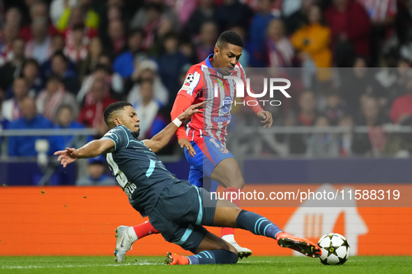 Samuel Lino left winger of Atletico de Madrid and Brazil and Benjamin Henrichs right-back of RB Leipzig and Germany compete for the ball dur...