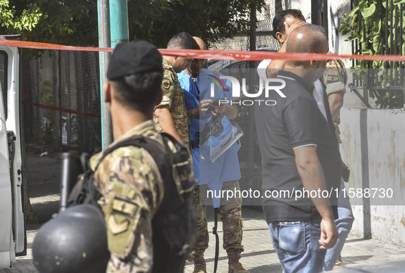 An explosives expert from the Lebanese army prepares to remove a bomb thrown in a small garden next to a public road in Beirut, Lebanon, on...