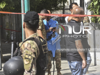 An explosives expert from the Lebanese army prepares to remove a bomb thrown in a small garden next to a public road in Beirut, Lebanon, on...