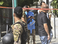 An explosives expert from the Lebanese army prepares to remove a bomb thrown in a small garden next to a public road in Beirut, Lebanon, on...