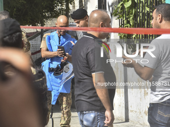 An explosives expert from the Lebanese army prepares to remove a bomb thrown in a small garden next to a public road in Beirut, Lebanon, on...