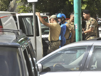 An explosives expert from the Lebanese army prepares to remove a bomb thrown in a small garden next to a public road in Beirut, Lebanon, on...