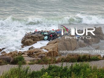 Floating balls for offshore farming come ashore with waves affected by Typhoon Pulasan in Qingdao, China, on September 20, 2024. (