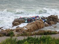 Floating balls for offshore farming come ashore with waves affected by Typhoon Pulasan in Qingdao, China, on September 20, 2024. (