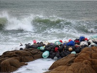 Floating balls for offshore farming come ashore with waves affected by Typhoon Pulasan in Qingdao, China, on September 20, 2024. (