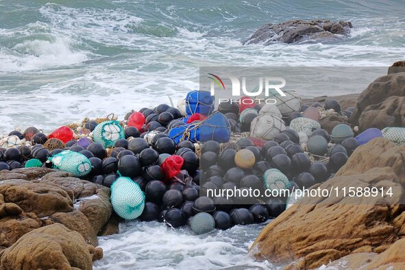 Floating balls for offshore farming come ashore with waves affected by Typhoon Pulasan in Qingdao, China, on September 20, 2024. 