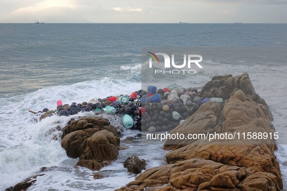 Floating balls for offshore farming come ashore with waves affected by Typhoon Pulasan in Qingdao, China, on September 20, 2024. 