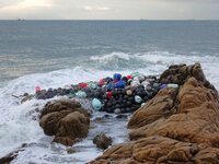 Floating balls for offshore farming come ashore with waves affected by Typhoon Pulasan in Qingdao, China, on September 20, 2024. (