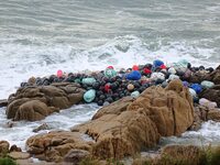 Floating balls for offshore farming come ashore with waves affected by Typhoon Pulasan in Qingdao, China, on September 20, 2024. (