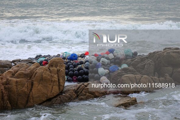 Floating balls for offshore farming come ashore with waves affected by Typhoon Pulasan in Qingdao, China, on September 20, 2024. 