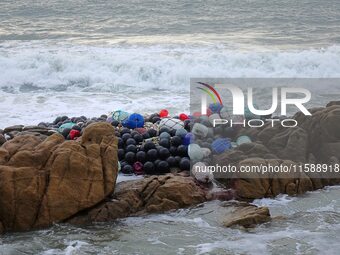 Floating balls for offshore farming come ashore with waves affected by Typhoon Pulasan in Qingdao, China, on September 20, 2024. (