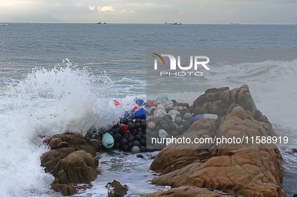 Floating balls for offshore farming come ashore with waves affected by Typhoon Pulasan in Qingdao, China, on September 20, 2024. 