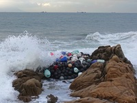 Floating balls for offshore farming come ashore with waves affected by Typhoon Pulasan in Qingdao, China, on September 20, 2024. (